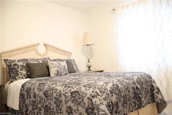 a bedroom with a bed and a night stand