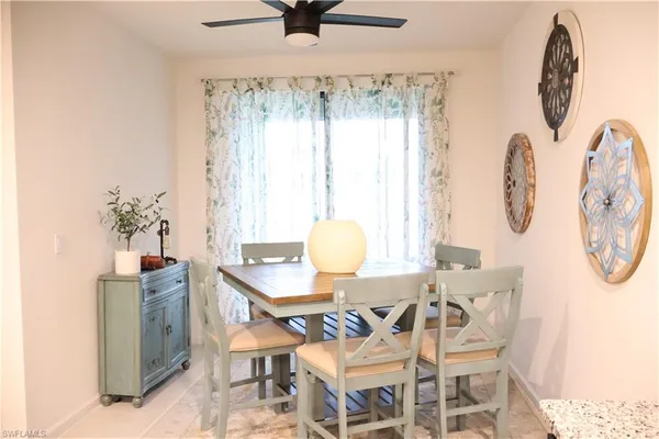 a dining room with furniture and window
