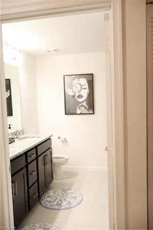 a bathroom with a sink a toilet and mirror