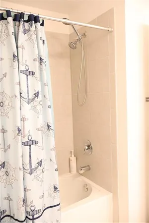 a bathroom with a shower and a sink