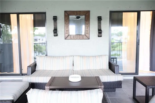 a living room with furniture and large windows