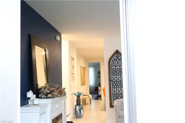 a view of a hallway with two windows