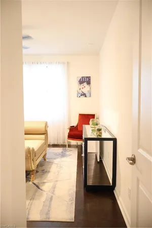 a view of a hallway with seating area