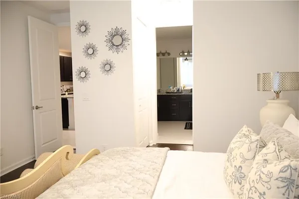 a bedroom with a bed and a mirror