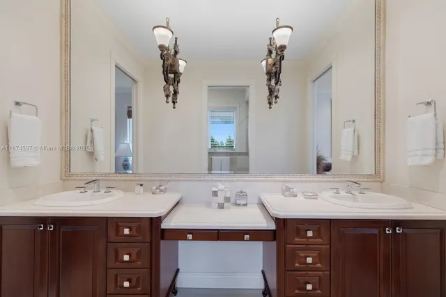 a view of a white house with a yard table and chairs