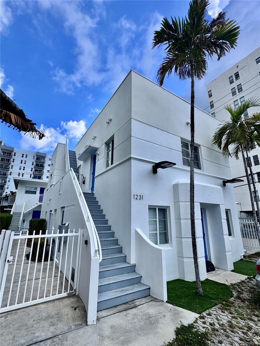 1231 13th Street, Unit 2 Miami Beach, FL 33139 - Photo 1 of 8 front view of a house with a palm tree