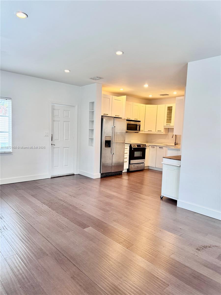 1231 13th Street, Unit 2 Miami Beach, FL 33139 - Photo 3 of 8 a kitchen with stainless steel appliances a refrigerator and a stove top oven