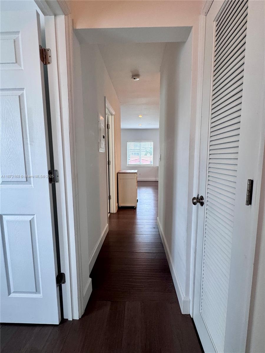 1231 13th Street, Unit 2 Miami Beach, FL 33139 - Photo 5 of 8 a view of a hallway with wooden floor and a living room