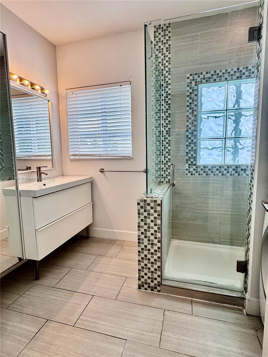 1231 13th Street, Unit 2 Miami Beach, FL 33139 - Photo 6 of 8 a bathroom with a bathtub and window
