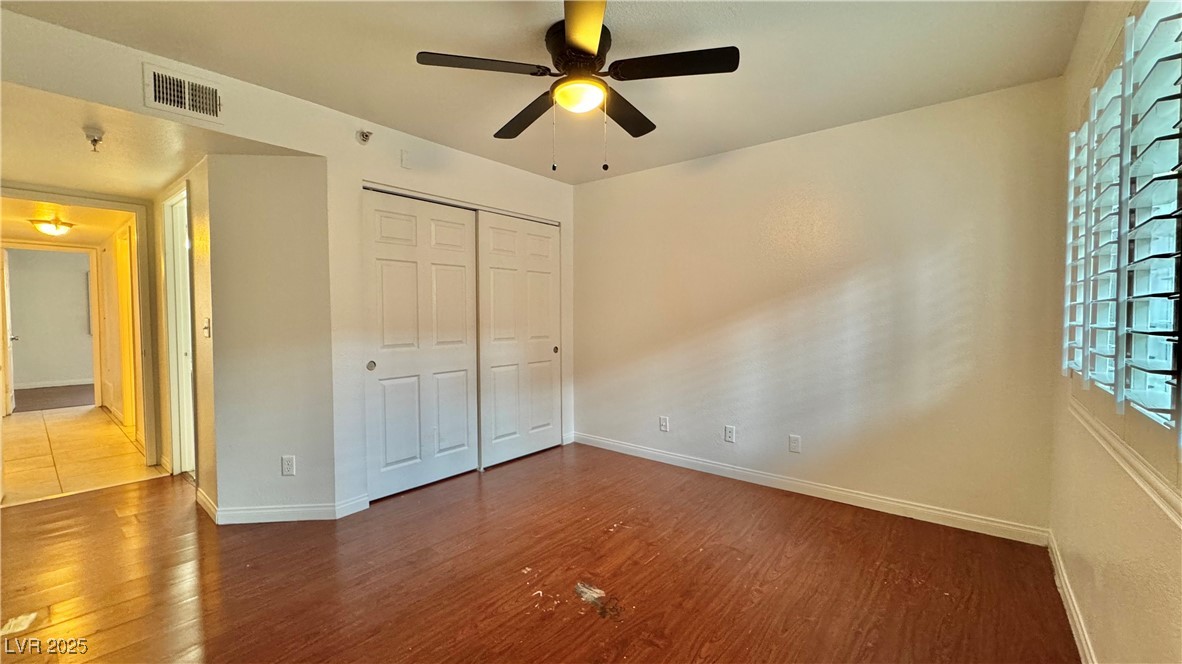 2750 South Durango Drive, Unit 2100 Las Vegas, NV 89117 - Photo 19 of 30 Unfurnished bedroom with wood finished floors, a closet, and a ceiling fan