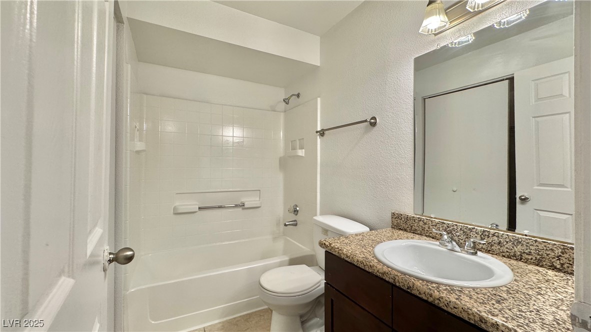 2750 South Durango Drive, Unit 2100 Las Vegas, NV 89117 - Photo 21 of 30 Bathroom featuring vanity, shower / bathtub combination, and a textured wall