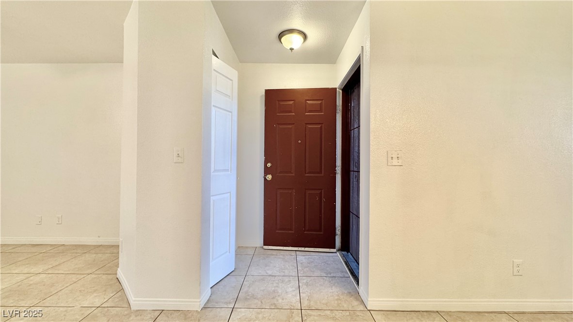 2750 South Durango Drive, Unit 2100 Las Vegas, NV 89117 - Photo 4 of 30 Foyer entrance with light tile patterned floors and baseboards