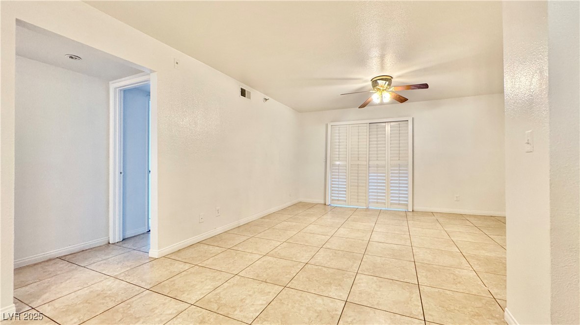2750 South Durango Drive, Unit 2100 Las Vegas, NV 89117 - Photo 5 of 30 Empty room featuring ceiling fan and light tile patterned flooring