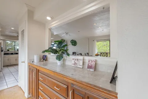 a hallway with sink and mirror