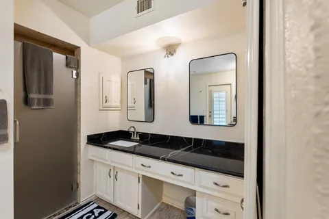 a view of staircase with white walls and white door