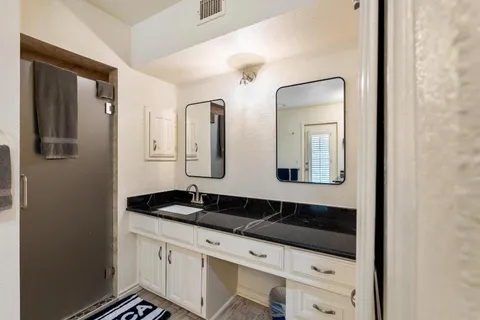 a bathroom with a sink and a mirror