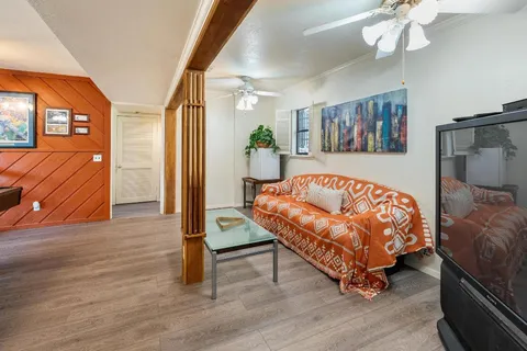 a bedroom with a bed and a mirror on the dresser