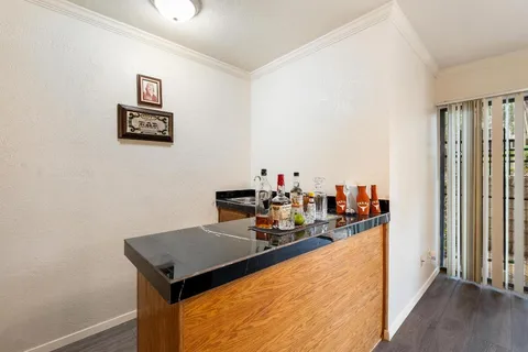 a view of a workspace with furniture and wooden floor