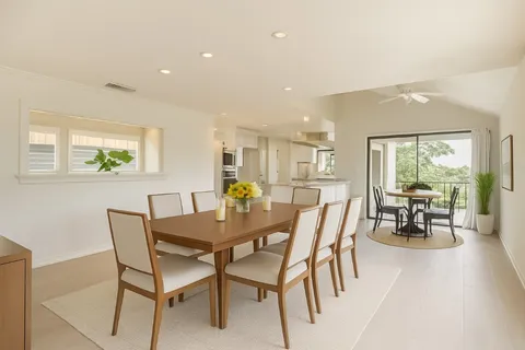 a view of a dining room with furniture and a potted plant