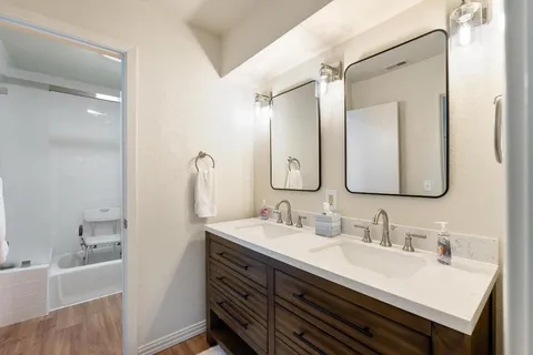 a bathroom with a sink double vanity and a mirror