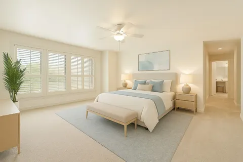 a spacious bedroom with a large bed and a chandelier