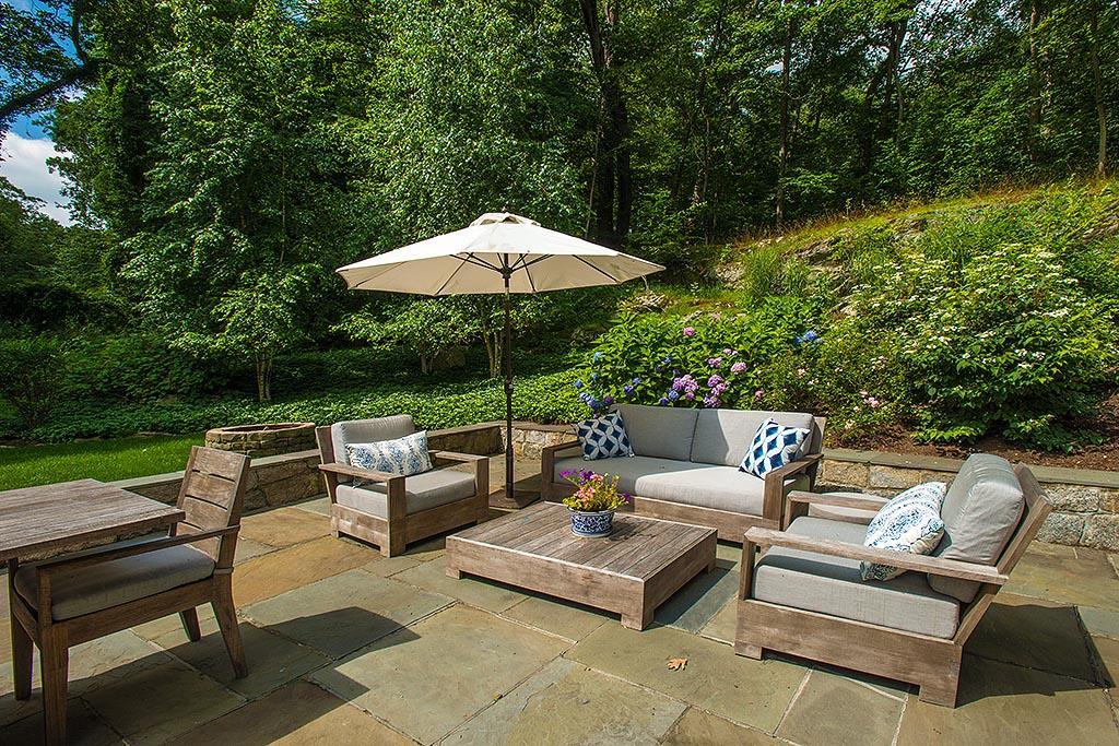 2 Carriage Road Cos Cob, CT 06807 - Photo 22 of 25 a view of a patio with couches table and chairs under an umbrella with a barbeque