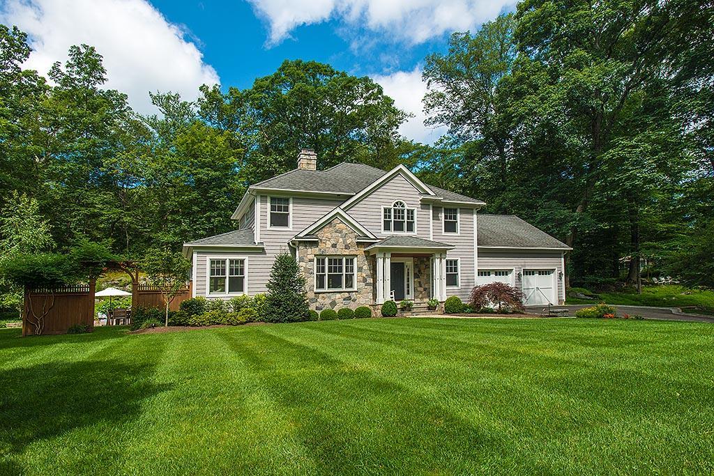 2 Carriage Road Cos Cob, CT 06807 - Photo 25 of 25 a front view of a house with a garden and trees