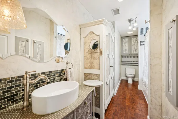 a bathroom with a sink a toilet and shower