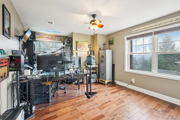 a view of a livingroom with furniture window and wooden floor