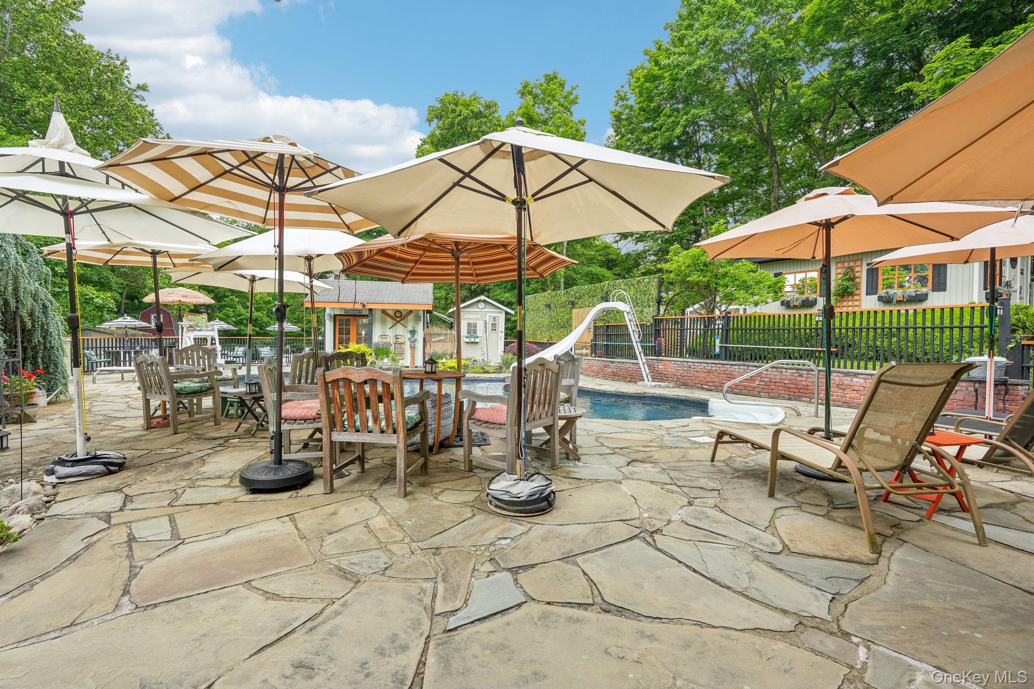 55 Buckberg Road Tomkins Cove, NY 10986 - Photo 24 of 46 a view of patio with chairs and table under an umbrella