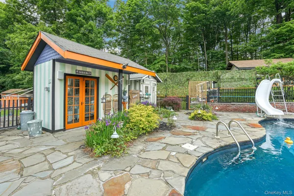 a view of a chair and table in backyard of the house