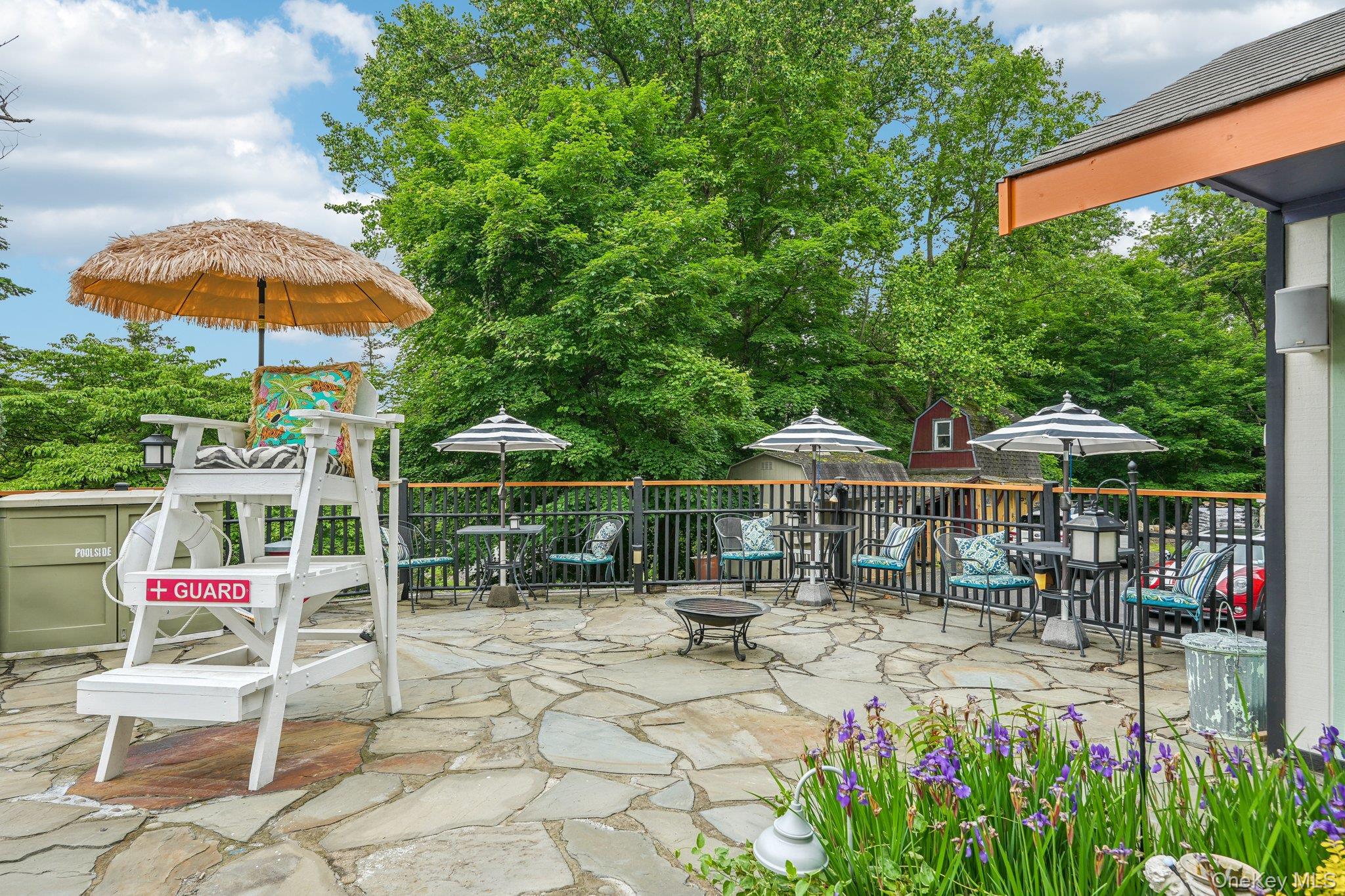 55 Buckberg Road Tomkins Cove, NY 10986 - Photo 26 of 46 a patio with a table and chairs under an umbrella