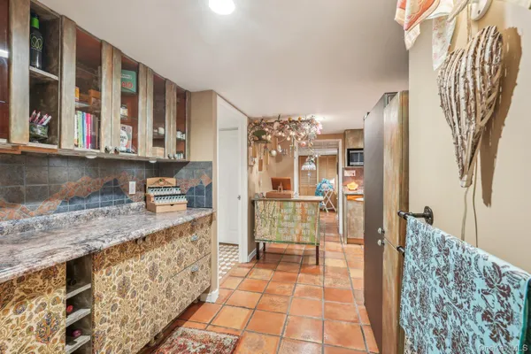 a kitchen with stainless steel appliances kitchen island granite countertop a refrigerator and a sink