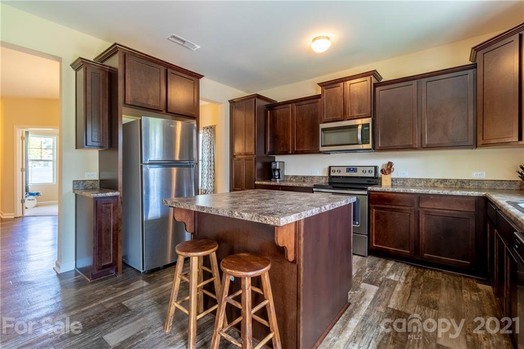 13010 Hill Pine Road Midland, NC 28107 - Photo 12 of 32 a kitchen with stainless steel appliances granite countertop a stove a refrigerator and a refrigerator