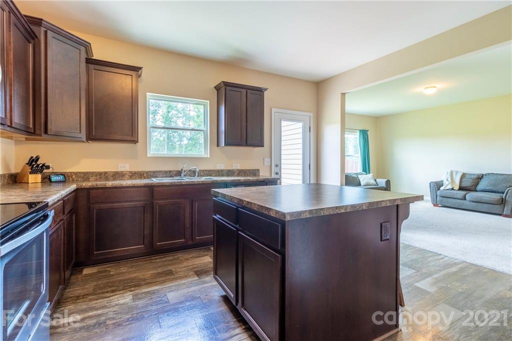13010 Hill Pine Road Midland, NC 28107 - Photo 14 of 32 a kitchen with granite countertop a sink and a stove