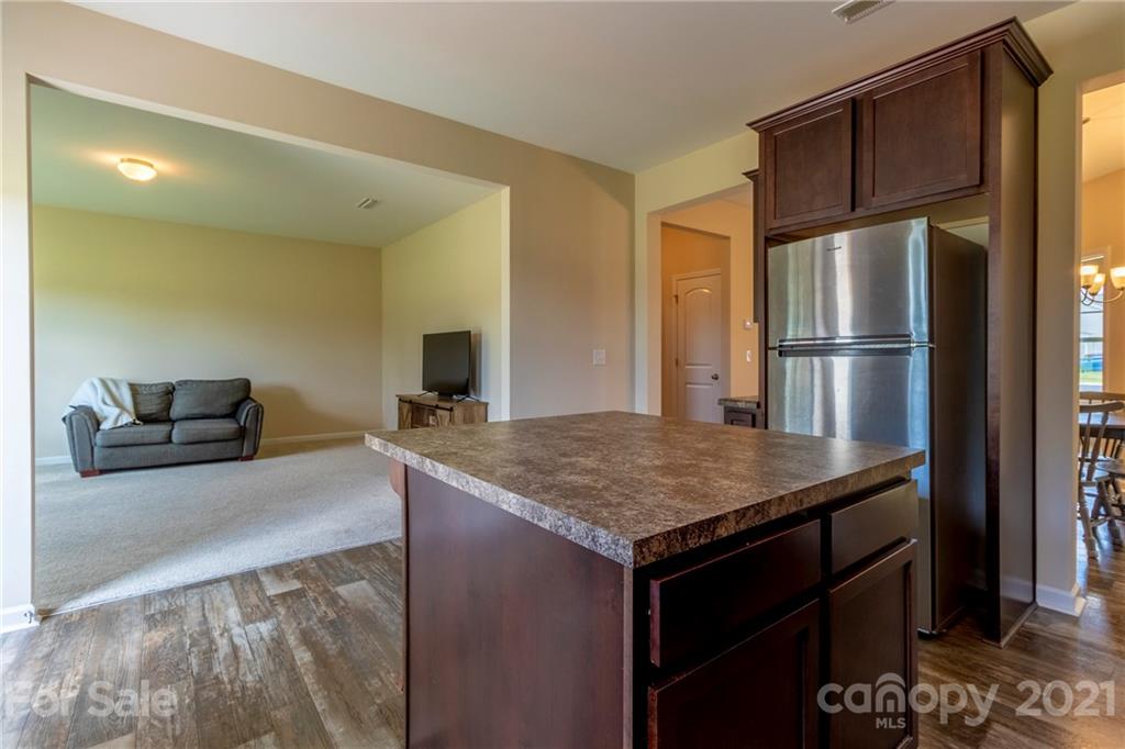 13010 Hill Pine Road Midland, NC 28107 - Photo 15 of 32 a kitchen with kitchen island a counter top space cabinets and stainless steel appliances