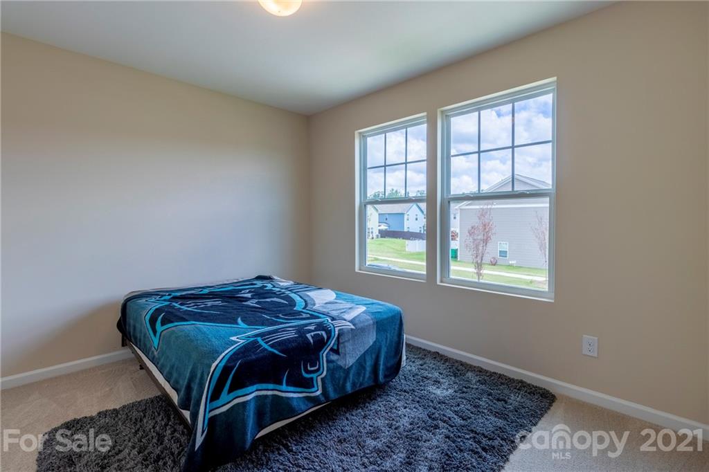 13010 Hill Pine Road Midland, NC 28107 - Photo 17 of 32 a bed sitting in a bedroom next to a window