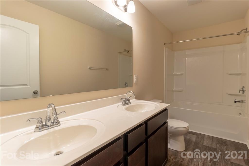 13010 Hill Pine Road Midland, NC 28107 - Photo 18 of 32 a bathroom with a sink a toilet and shower