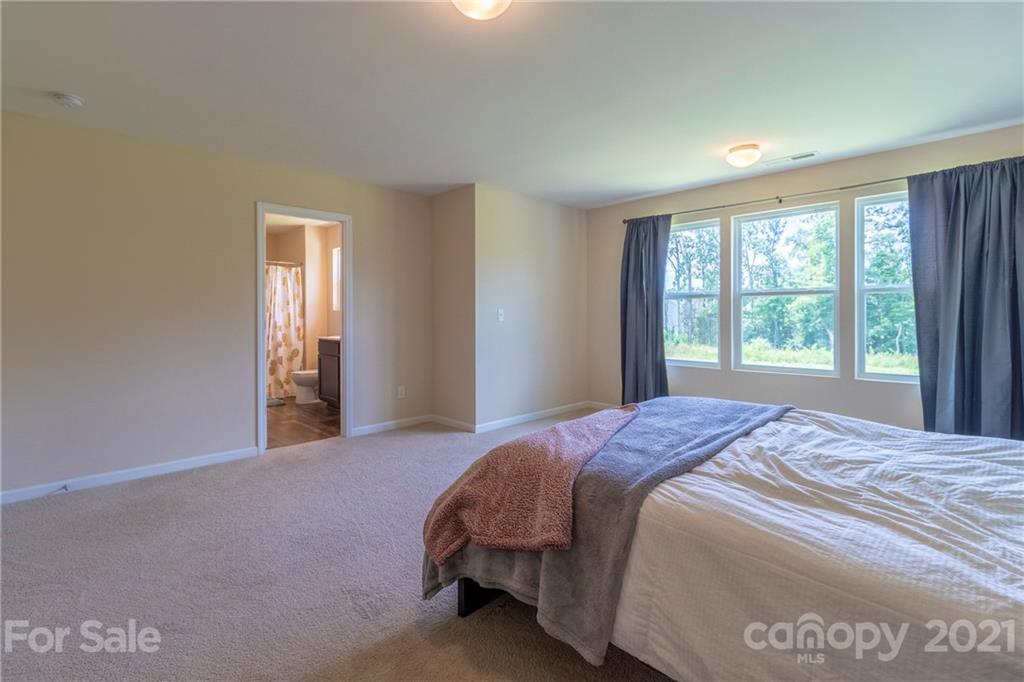 13010 Hill Pine Road Midland, NC 28107 - Photo 20 of 32 a bedroom with a bed and window