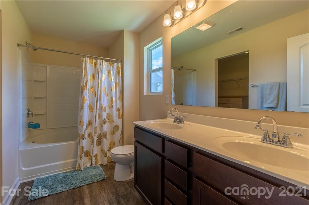 13010 Hill Pine Road Midland, NC 28107 - Photo 21 of 32 a bathroom with a granite countertop sink toilet and shower