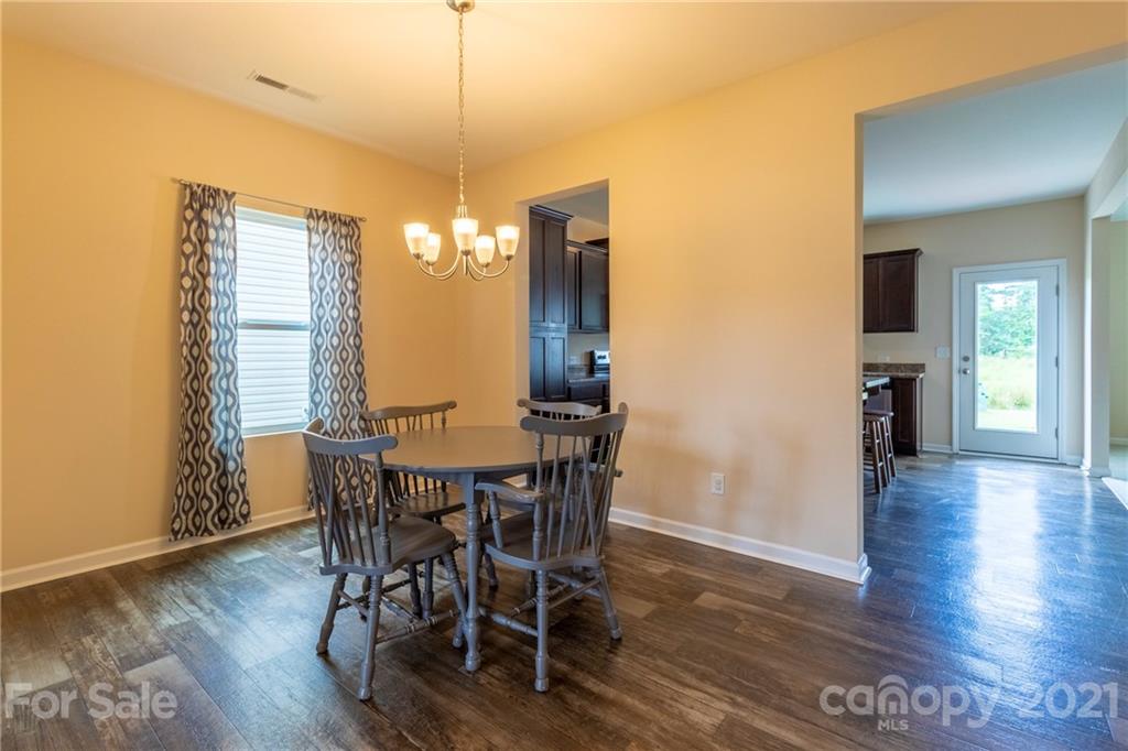13010 Hill Pine Road Midland, NC 28107 - Photo 7 of 32 a view of a dining room with furniture and wooden floor