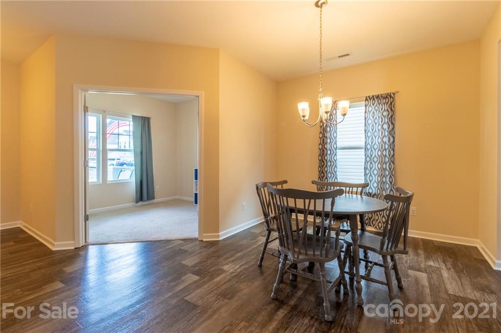 13010 Hill Pine Road Midland, NC 28107 - Photo 8 of 32 a view of a dining room with furniture and wooden floor