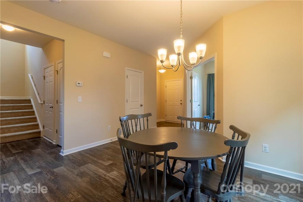 13010 Hill Pine Road Midland, NC 28107 - Photo 9 of 32 a view of a dining room with furniture and wooden floor