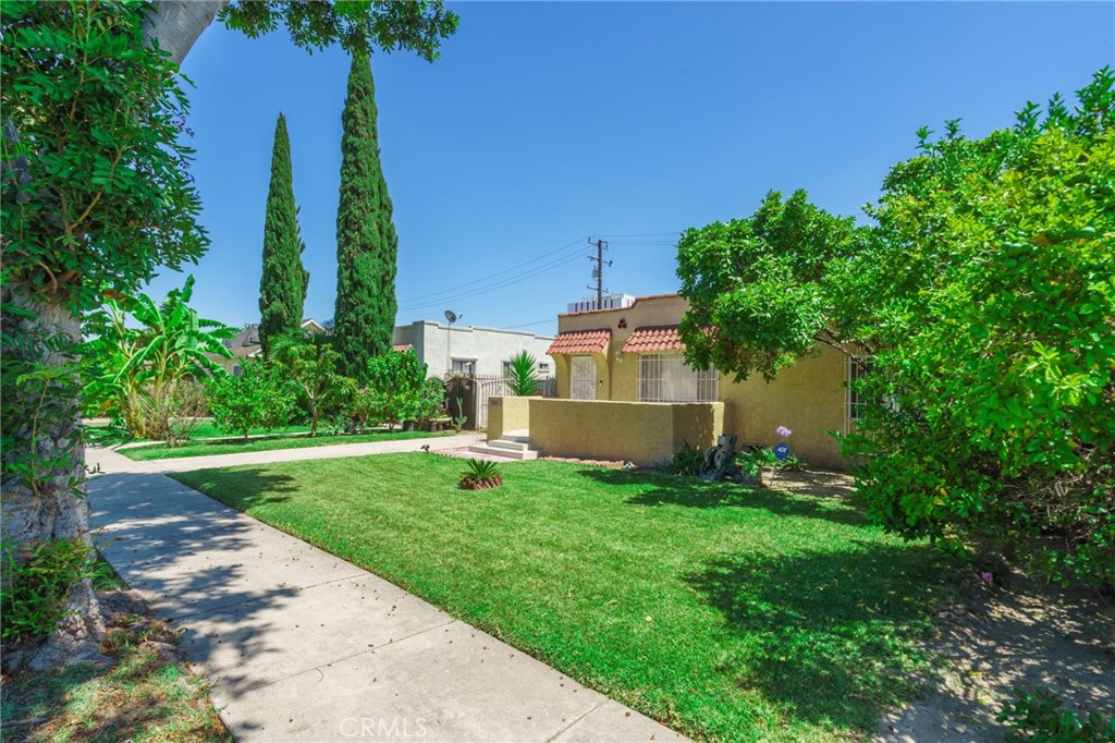 346 West School Street Compton, CA 90220 - Photo 2 of 29 a view of a house with a yard and potted plants