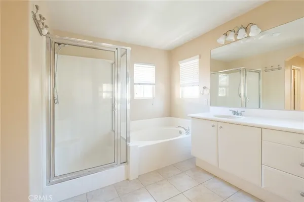a spacious bathroom with a bathtub shower and sink
