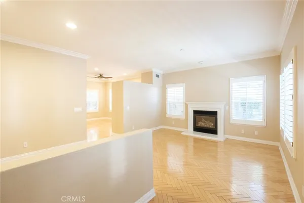 a view of an empty room with a fireplace and a window