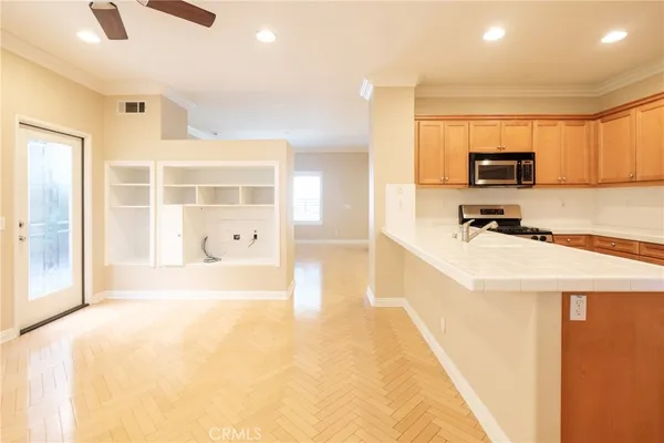 a view of a kitchen with a sink and a refrigerator