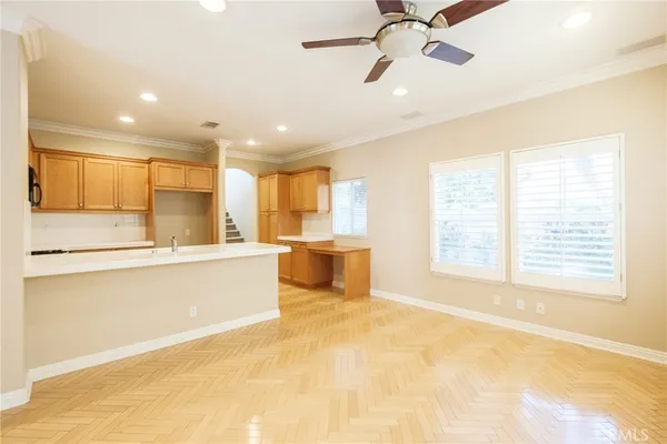 a large white kitchen with a large window