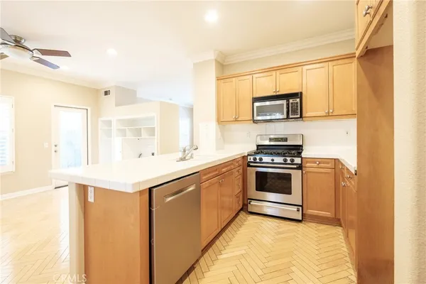 a kitchen with stainless steel appliances a stove and a refrigerator