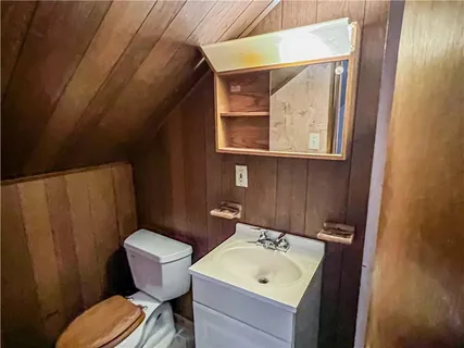 a bathroom with a sink mirror and toilet